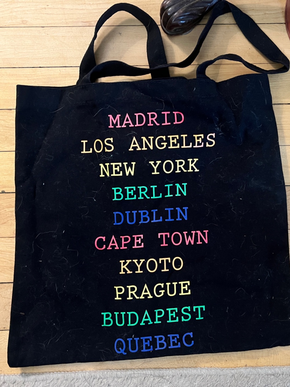 Black City Names Canvas Tote Bag with Multicolor Text
